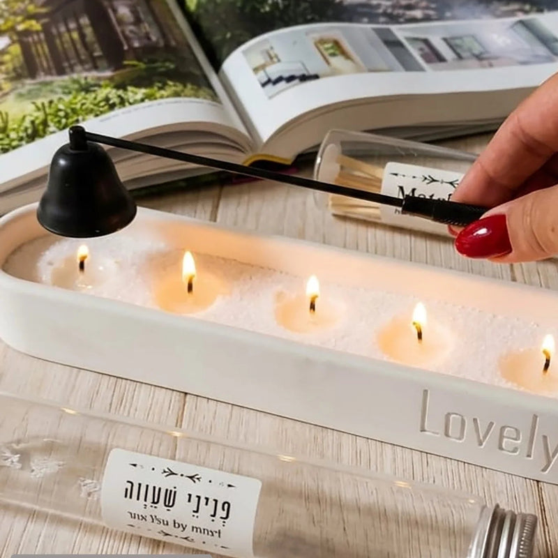 Candle holder with candles and a hand holding a black candlestick, with 'yezika by mari' branding.